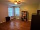 Bright ' bedroom featuring hardwood floors, and two windows with sheer curtains at 6211 Oak River Ter, Port Orange, FL 32127