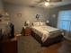 Cozy bedroom featuring a comfortable bed, dresser, and hardwood floors at 6211 Oak River Ter, Port Orange, FL 32127