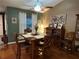 Traditional dining room with vaulted ceiling, wood table, and plenty of seating at 6211 Oak River Ter, Port Orange, FL 32127