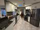 Modern kitchen with stainless steel appliances, granite countertops, and sleek white cabinets at 6211 Oak River Ter, Port Orange, FL 32127