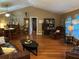 Open-concept living area with hardwood floors, vaulted ceiling, and ample natural light at 6211 Oak River Ter, Port Orange, FL 32127