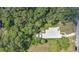 Drone's eye view of the property's layout, surrounded by green canopy, illustrating its private setting at 626 Cannon St, Daytona Beach, FL 32114