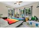 A spacious bedroom with two windows offering abundant natural light and a view of the surrounding greenery at 626 Cannon St, Daytona Beach, FL 32114