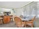 Cozy dining area featuring a glass table and wicker chairs, with natural light filtering through sheer curtains at 626 Cannon St, Daytona Beach, FL 32114