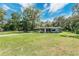 Charming single-story home with well-maintained lawn, surrounded by lush trees, offering a serene curb appeal at 626 Cannon St, Daytona Beach, FL 32114