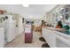 Functional kitchen featuring white cabinets, a dining area, and ample natural light at 626 Cannon St, Daytona Beach, FL 32114