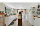 A functional kitchen with white cabinets, a dining area, and ample natural light from a nearby window at 626 Cannon St, Daytona Beach, FL 32114