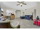 Spacious living room features tile flooring, comfortable blue sectional, and natural light for a warm, inviting space at 626 Cannon St, Daytona Beach, FL 32114