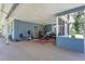 Covered patio featuring blue walls, ceiling fan, and ample space for outdoor relaxation and entertaining at 626 Cannon St, Daytona Beach, FL 32114