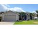 Charming single-story home with a well-manicured lawn and a two-car garage at 1693 Arash Cir, Port Orange, FL 32128