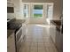 Well-lit eat-in kitchen with tiled floors and ample cabinet space at 1693 Arash Cir, Port Orange, FL 32128