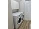Functional laundry room with washer, dryer, and storage cabinets at 1693 Arash Cir, Port Orange, FL 32128