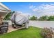 Backyard of home featuring boat on trailer, privacy fence, and artificial turf at 202 Yorkville Pl, Debary, FL 32713