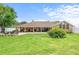 Expansive backyard with a brick patio, covered porch, and outdoor seating area at 202 Yorkville Pl, Debary, FL 32713