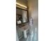 Cozy bathroom featuring a pedestal sink, ornate mirror, and decorative towel rack at 202 Yorkville Pl, Debary, FL 32713