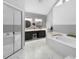 Modern bathroom featuring a soaking tub, a separate shower, and double sink vanity at 202 Yorkville Pl, Debary, FL 32713