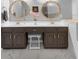 Bathroom featuring a double vanity with modern fixtures and decorative mirrors at 202 Yorkville Pl, Debary, FL 32713