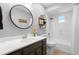 Bright bathroom featuring a single vanity with modern fixtures, and a shower over tub at 202 Yorkville Pl, Debary, FL 32713