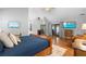 Bright bedroom with hardwood floors, a vaulted ceiling, and sliding glass doors to the backyard at 202 Yorkville Pl, Debary, FL 32713