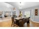 Bright dining room with wood floors, a large bay window, and stylish decor creating an inviting atmosphere at 202 Yorkville Pl, Debary, FL 32713