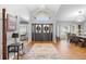 Inviting foyer with high ceilings, hardwood floors, and views into living and dining areas at 202 Yorkville Pl, Debary, FL 32713