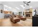 Open living room featuring a brick fireplace, comfortable seating, and views into the kitchen at 202 Yorkville Pl, Debary, FL 32713