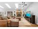 Cozy living room with a brick fireplace, comfortable seating, and a large screen television at 202 Yorkville Pl, Debary, FL 32713
