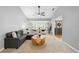 Serene living room with a comfortable sectional sofa, accent chairs, and natural lighting at 202 Yorkville Pl, Debary, FL 32713