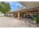 Spacious brick patio with ample seating under a covered structure, perfect for outdoor living at 202 Yorkville Pl, Debary, FL 32713