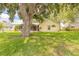 Enjoy the lush backyard with mature trees, well-manicured lawn, and a screened-in porch at 212 Mallard Ln, Daytona Beach, FL 32119