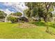 Expansive backyard featuring a well-maintained lawn, landscaping, and a screened-in porch at 212 Mallard Ln, Daytona Beach, FL 32119