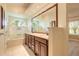 Bathroom with granite countertop vanity, soaking tub, large mirror, and tile floors at 212 Mallard Ln, Daytona Beach, FL 32119