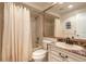 Bathroom showcasing a vanity, mirror, shower with curtain, and toilet at 212 Mallard Ln, Daytona Beach, FL 32119