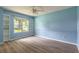Sunlit bedroom with built-in shelves, updated flooring, and a large window at 212 Mallard Ln, Daytona Beach, FL 32119