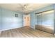 Light blue bedroom features a mirrored closet and updated flooring at 212 Mallard Ln, Daytona Beach, FL 32119