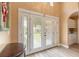 Bright entryway with glass doors, providing ample natural light and a welcoming view of the outdoors at 212 Mallard Ln, Daytona Beach, FL 32119