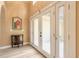 Inviting entryway featuring glass doors, hardwood flooring, and contemporary decor at 212 Mallard Ln, Daytona Beach, FL 32119