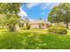 Charming home exterior with a lush green lawn and mature landscaping under a bright sky at 212 Mallard Ln, Daytona Beach, FL 32119