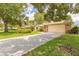 View of the home's front exterior showing the driveway, manicured lawn, and mature landscaping at 212 Mallard Ln, Daytona Beach, FL 32119