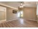 Spacious living room featuring wood floors, a ceiling fan, and a sunny window at 212 Mallard Ln, Daytona Beach, FL 32119