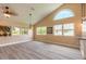 Cozy living room with large windows, vaulted ceiling, and wood flooring creates a warm atmosphere at 212 Mallard Ln, Daytona Beach, FL 32119