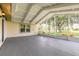 Enclosed patio with concrete floor, ceiling fan and view of landscaped yard at 212 Mallard Ln, Daytona Beach, FL 32119