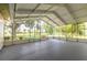 Bright and airy screened porch with a view of the well-manicured lawn and tropical landscaping at 212 Mallard Ln, Daytona Beach, FL 32119