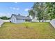 View of the spacious backyard with screened in porch, privacy fence and mature trees at 2237 Clearwater Dr, Deltona, FL 32738
