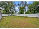 Large backyard has a white privacy fence surrounding the perimeter and a mature tree at 2237 Clearwater Dr, Deltona, FL 32738