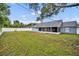 The spacious, lush backyard is completely fenced in, surrounded by mature trees at 2237 Clearwater Dr, Deltona, FL 32738