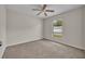 This bedroom features plush carpet, a standard window, neutral paint and a ceiling fan at 2237 Clearwater Dr, Deltona, FL 32738
