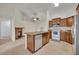 Kitchen with stainless appliances and view of the living room with fireplace at 2237 Clearwater Dr, Deltona, FL 32738