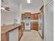 Bright kitchen featuring wooden cabinets and stainless steel appliances at 2237 Clearwater Dr, Deltona, FL 32738