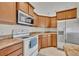 Kitchen features stainless steel appliances, wood cabinets, and a microwave at 2237 Clearwater Dr, Deltona, FL 32738